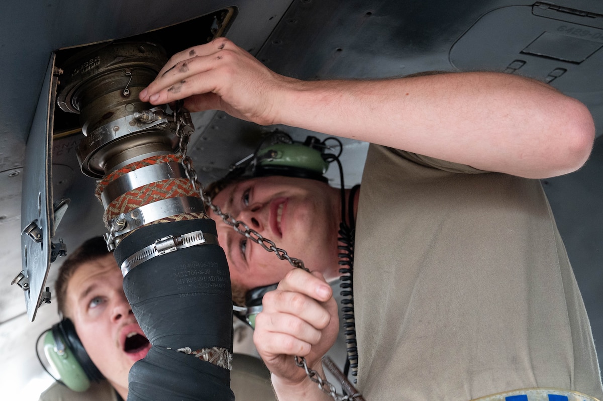 From left, U.S. Air Force Airman Nathaniel Hardin and Airman 1st Class Evan Wallace, 28th Bomber Generation Squadron B-1 propulsion systems apprentices, connect a bleed air hose to a B1-B Lancer during exercise Death Strike 25-03 at Dyess Air Force Base, Texas, Sept. 23, 2025. During the exercise the 28th BGS loaded inert JASSMs onto B-1B Lancers, refining procedures to improve sortie generation speed. (U.S. Air Force photo by Airman William Neal)