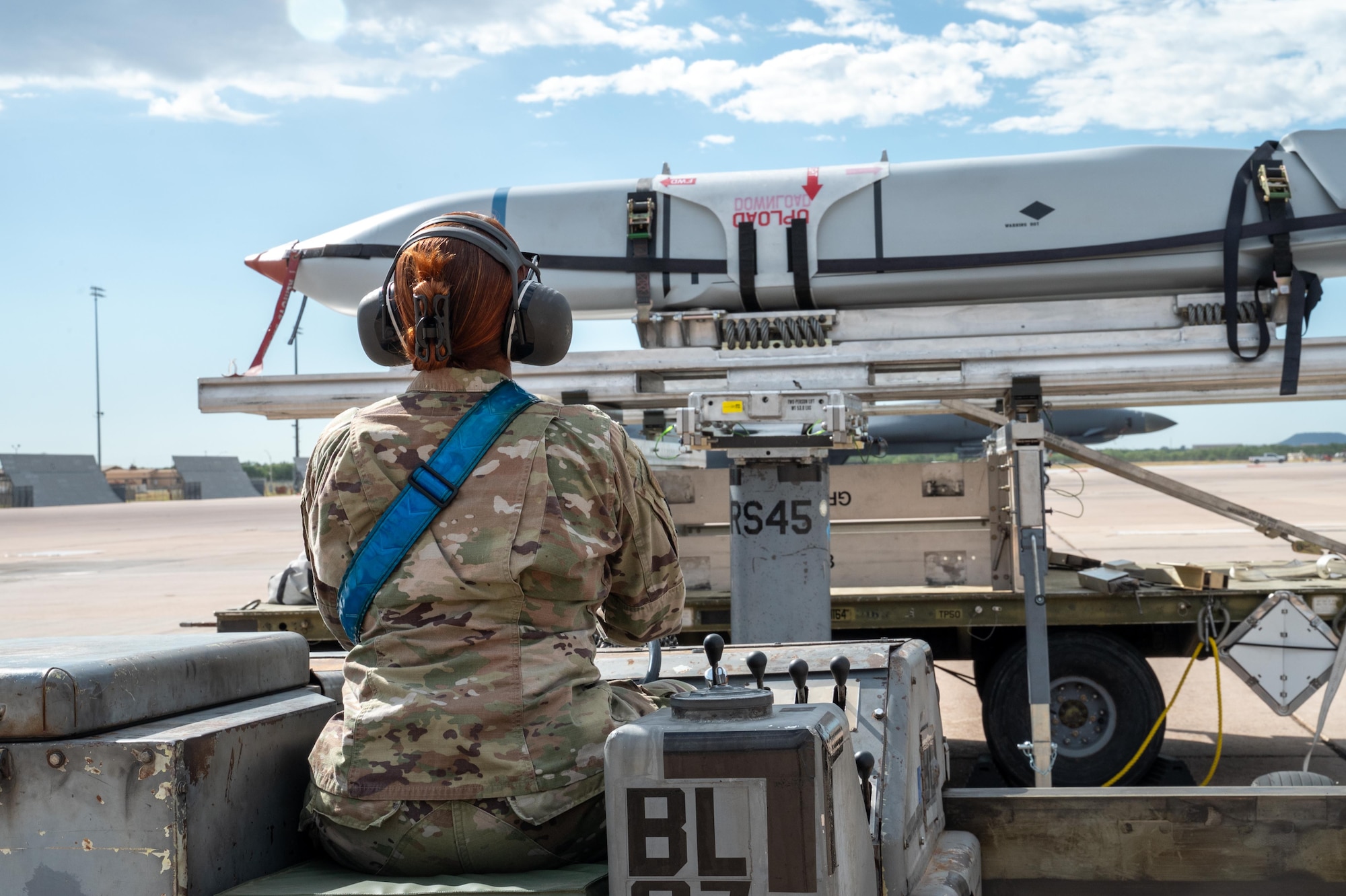U.S. Air Force Airman Madeline Guevara Rivera, 28th Bomber Generation Squadron weapons load crew member, operates an MHU-830 Lift Truck during exercise Death Strike 25-03 at Dyess Air Force Base, Texas, Sept. 23, 2025. During the exercise the 28th BGS loaded inert JASSMs onto B-1B Lancers, refining procedures to improve sortie generation speed. (U.S. Air Force photo by Airman 1st Class Adrien Tran)
