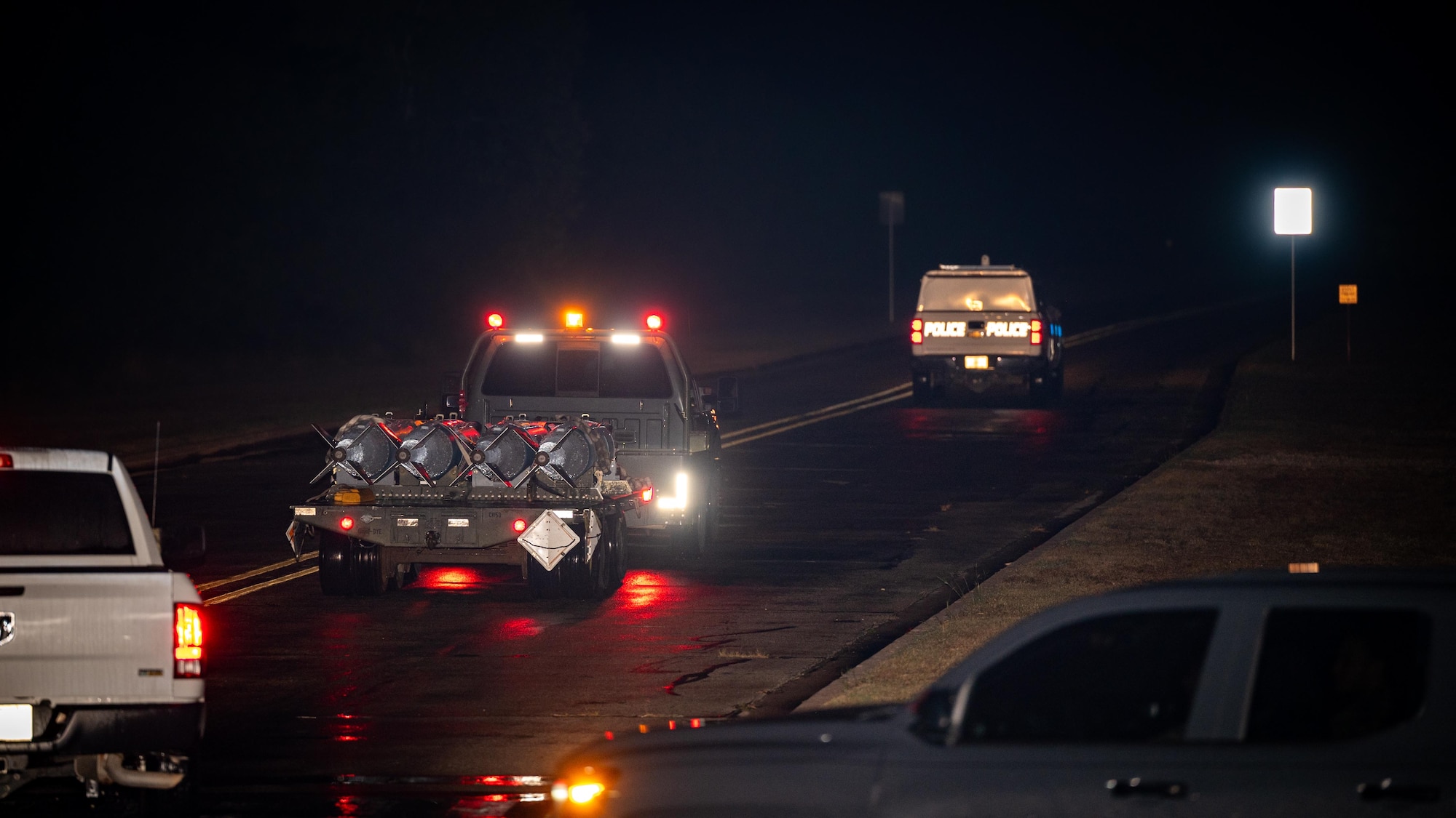 U.S. Air Force Airmen with the 7th Security Forces Squadron escort 7th Munitions Squadron Airmen while delivering munitions during exercise Death Strike 25-03 at Dyess Air Force Base, Texas, Sept. 24, 2025. The exercise scenario simulated a blockage of the primary munitions delivery route, requiring Airmen to use an alternate explosive route for the first time in more than a decade. (U.S. Air Force photo by Airman 1st Class Adrien Tran)