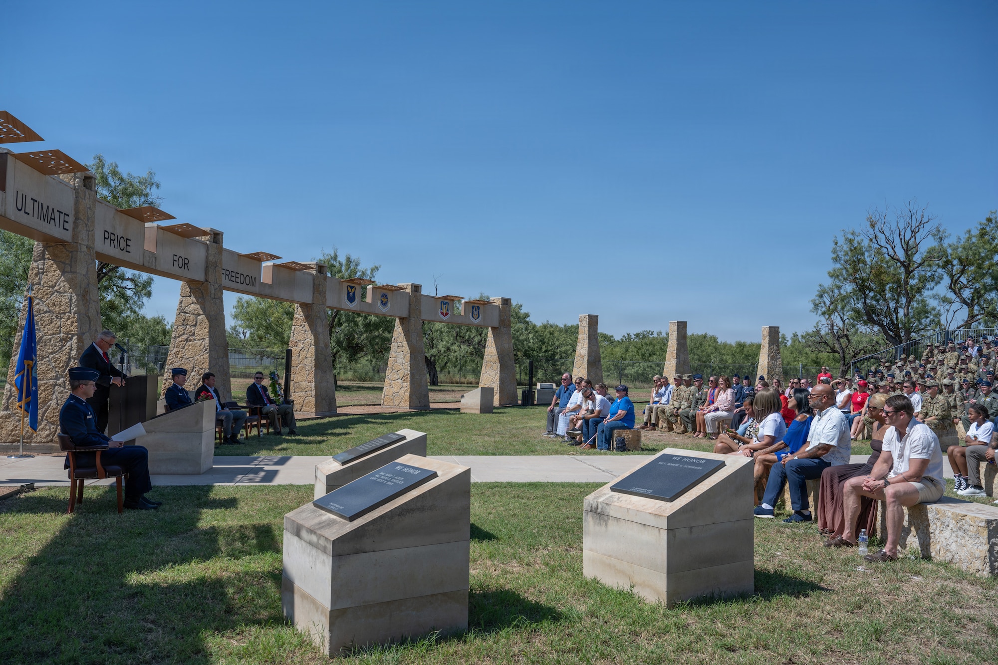 Gold Star family members of Airmen lost in TORQE 62 gather around a commemorative plaque