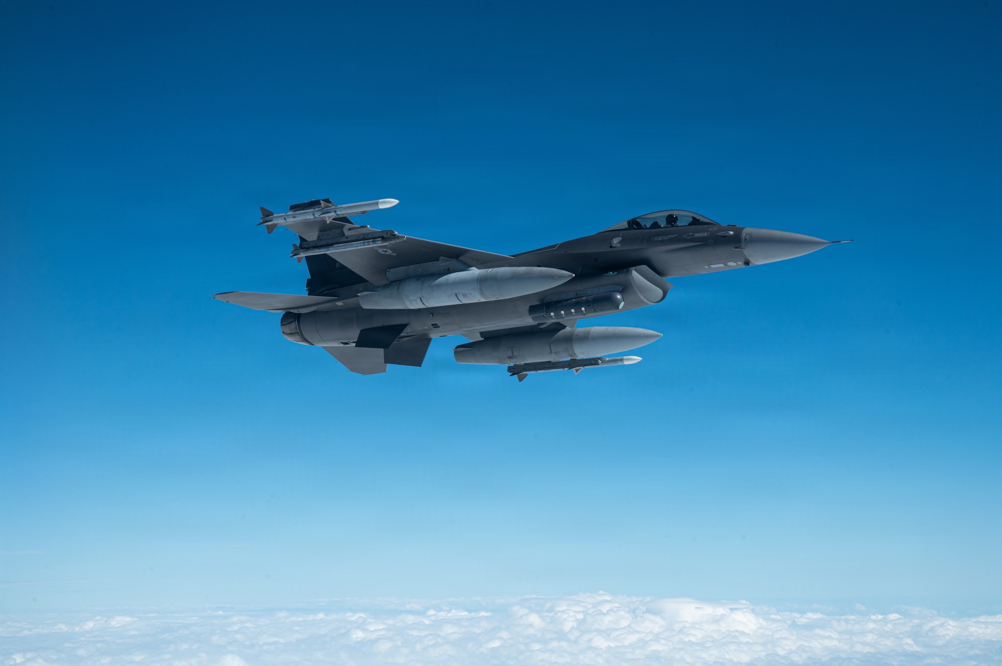 An aircraft flies over the Pacific Ocean.