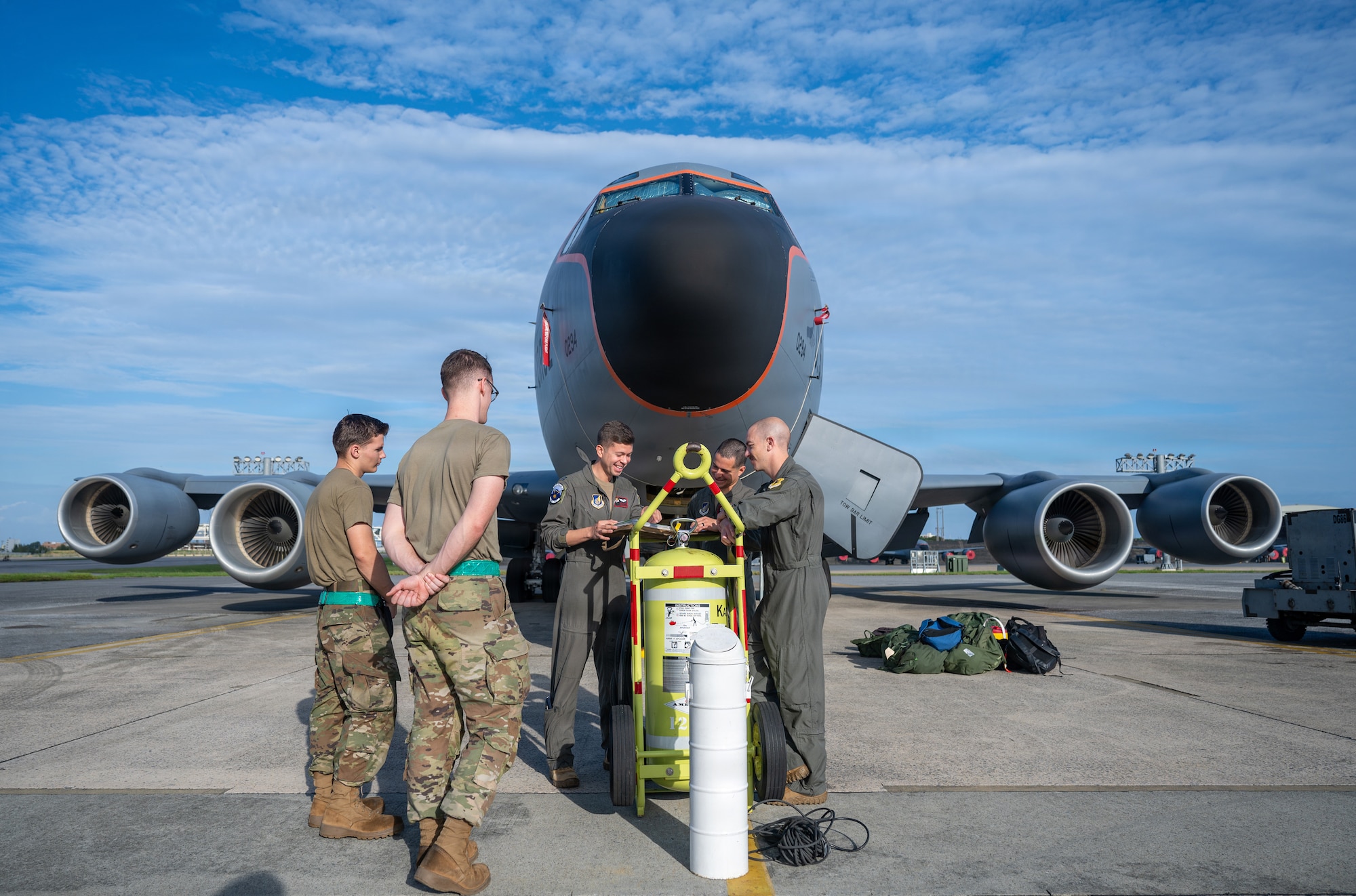 Service members briefs in front of an aircraft.