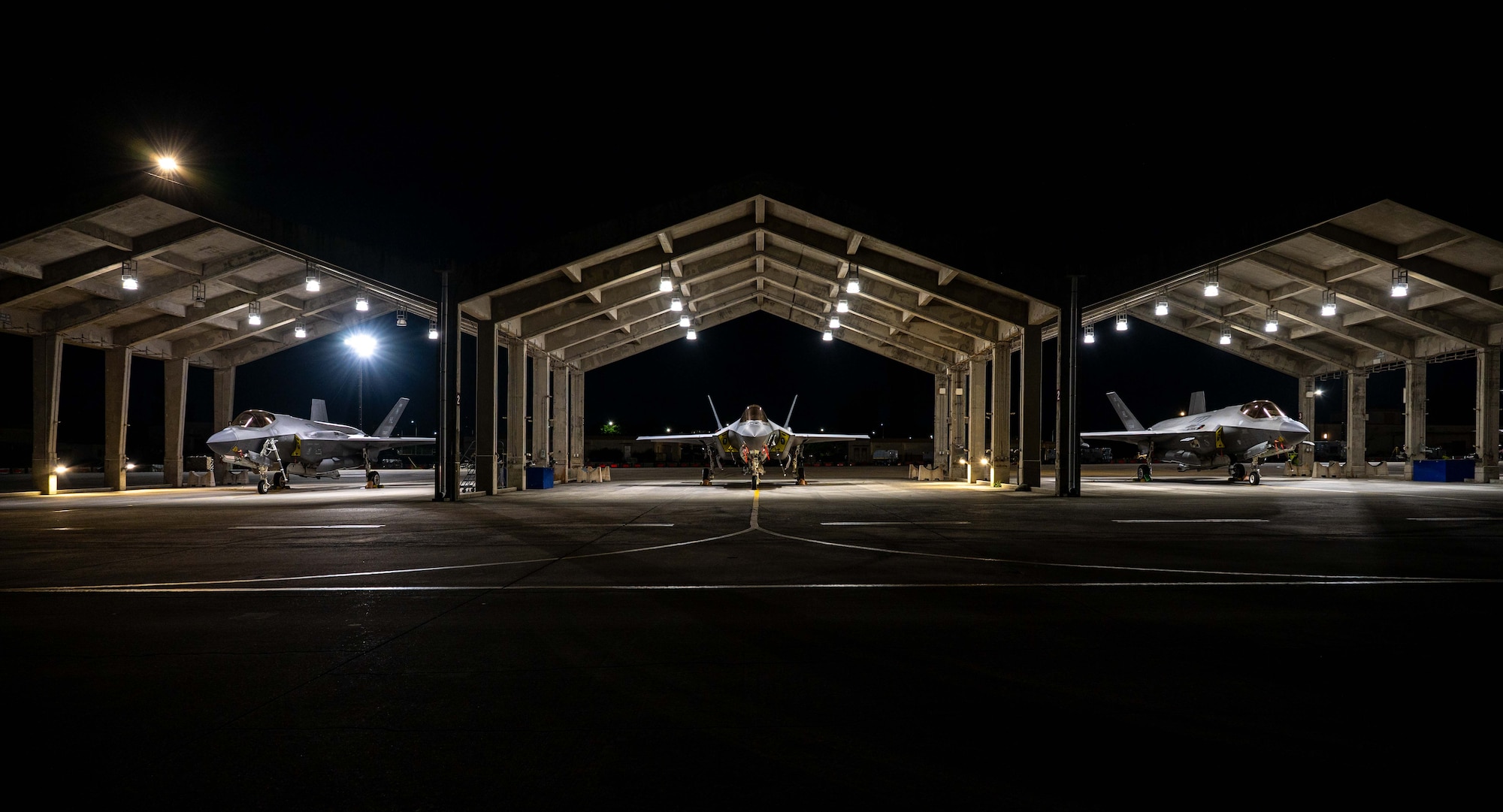 Three F-35A Lightning IIs sit static.