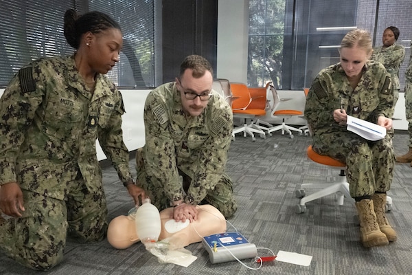 HOUSTON, Texas (Nov. 13, 2025) — Sailors practice CPR techniques during a Basic Life Support (BLS) training session at Navy Talent Acquisition Group Houston, while Hospital Corpsman 2nd Class Kayla Pahl evaluates their performance. The training helps prepare Sailors with essential life-saving skills used across Navy Medicine. (U.S. Navy photo by Mass Communication Specialist 1st Class Louis Rojas)