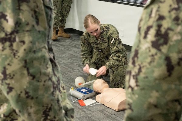 HOUSTON, Texas (Nov. 13, 2025) — Hospital Corpsman 2nd Class Kayla Pahl demonstrates automated external defibrillator (AED) pad placement during a Basic Life Support (BLS) training session at Navy Talent Acquisition Group Houston. As a BLS Instructor, Pahl provides Sailors with essential life-saving skills and draws from her fleet and instructional experience to mentor future Hospital Corpsmen. (U.S. Navy photo by Mass Communication Specialist 1st Class Louis Rojas)