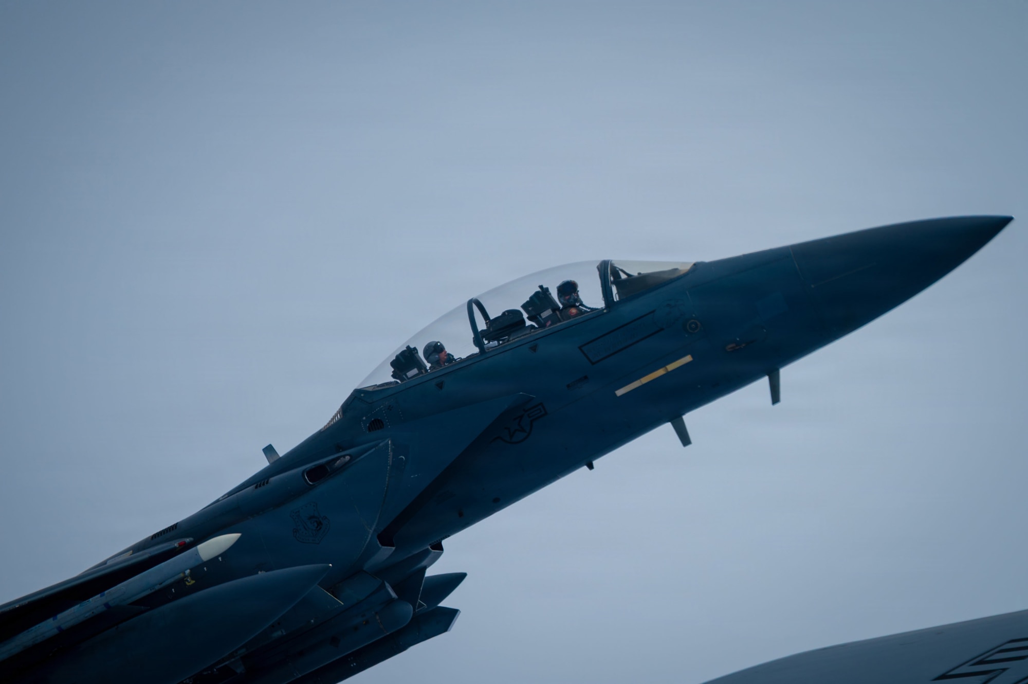 A U.S. Air Force F-15E Strike Eagle from the 48th Fighter Wing flies beside a KC-135 Stratotanker from the 100th Air Refueling Wing after receiving fuel during exercise Ocean Sky, over the Atlantic Ocean, Oct. 15, 2025.