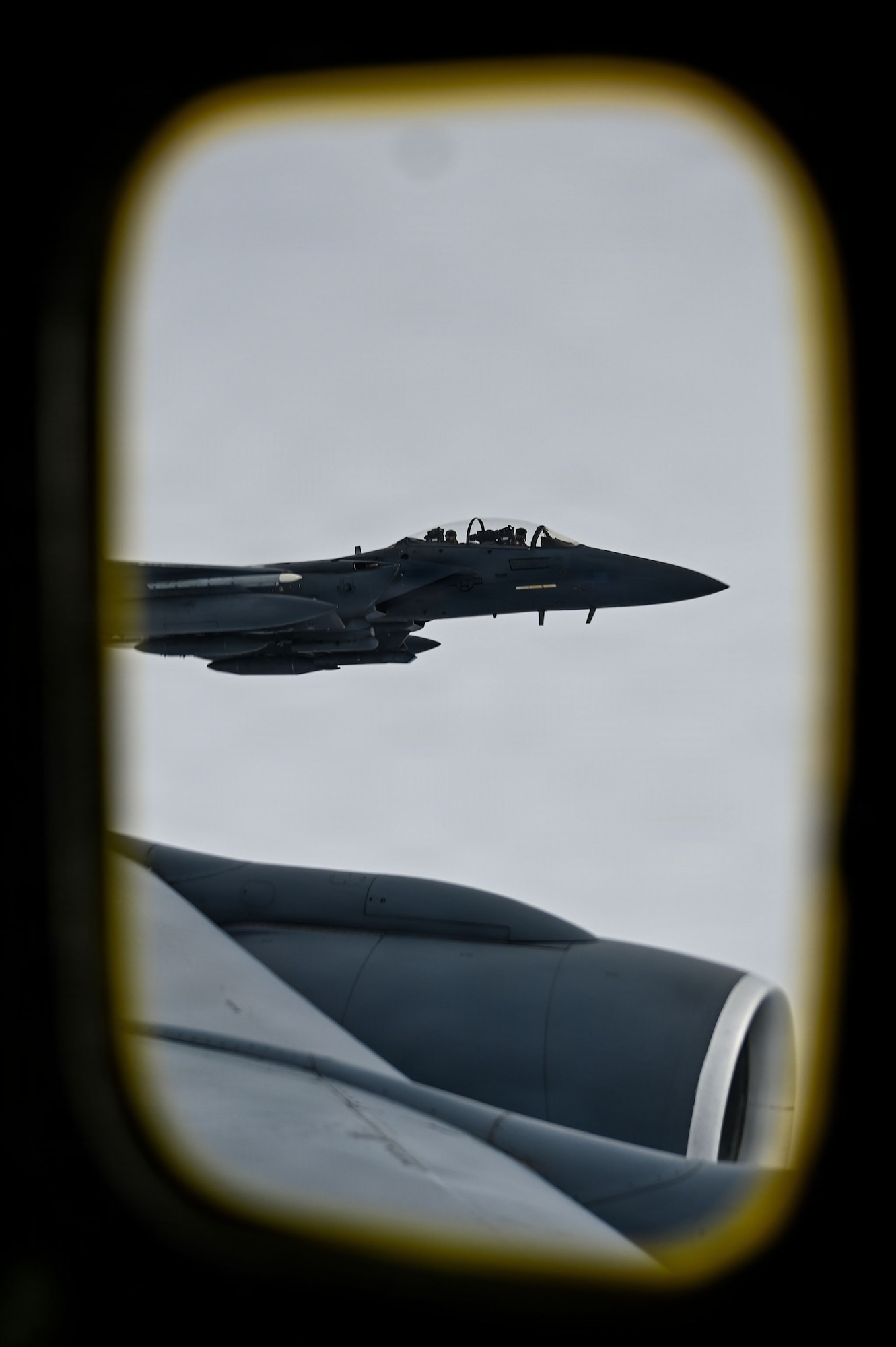 A U.S. Air Force F-15E Strike Eagle from the 48th Fighter Wing flies beside a KC-135 Stratotanker from the 100th Air Refueling Wing after receiving fuel during exercise Ocean Sky, over the Atlantic Ocean, Oct. 15, 2025.