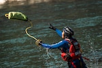 A member of the Special Malaysia Disaster Assistance and Rescue Team (SMART) tosses a water rescue throw bag to a swimmer during swift water rescue training in Spokane, Wash., Sept. 28, 2025. The Washington National Guard, along with the Spokane County Sheriff’s Department, hosted the Malaysian search and rescue unit for a week-long domestic response workshop. The workshop was coordinated through the State Partnership Program and was the first civilian-to-civilian engagement held in Washington state. Photo by Staff Sgt. Adeline Witherspoon