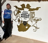 United States Air Force Tech Sgt. Dan Antonio Deladingco, 9th Mission Support Group (MSG) executive assistant, poses next to a sign for the 2025 International Practical Shooting Confederation (IPSC) Handgun World Shoot in Stilfontein, South Africa, Aug. 22, 2025.