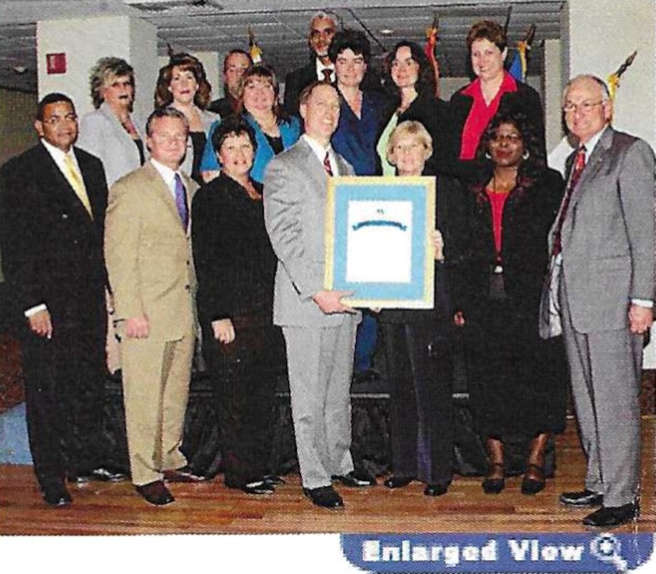 Group of people pose with an award