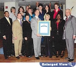 Group of people pose with an award