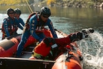 Members of the Special Malaysia Disaster Assistance and Rescue Team (SMART) pull a swimmer from the Spokane River during swift water rescue training in Spokane, Wash., Sept. 28, 2025. The Washington National Guard, along with the Spokane County Sheriff’s Department, hosted the Malaysian search and rescue unit for a week-long domestic response workshop. The workshop was coordinated through the State Partnership Program and was the first civilian-to-civilian engagement held in Washington state. Photo by Staff Sgt. Adeline Witherspoon.