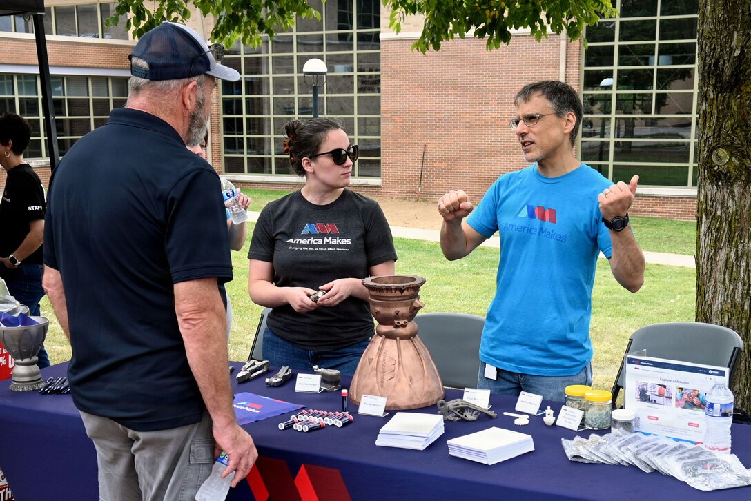 People at a table for a Manufacturing Month event with America Makes, a DoD Manufacturing Innovation Institute.