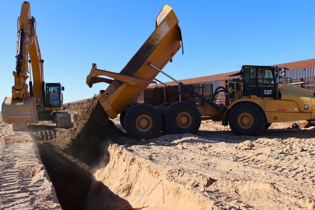 The U.S. Army Corps of Engineers contractors conduct trench stabilization construction in preparation for panel placement at the BMGR-1 border barrier project site near Yuma, Arizona, Oct. 28. USACE is replacing permanent border barriers along the southern border of the U.S. at the direction of the U.S. Army by the Secretary of War, in response to the presidential national emergency declaration dated Jan. 20, 2025, authorizing the use of Section 2803 of Title 10, U.S. Code.