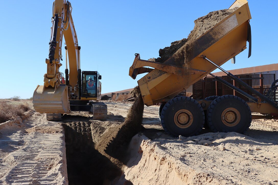 The U.S. Army Corps of Engineers contractors conduct trench stabilization construction in preparation for panel placement at the BMGR-1 border barrier project site near Yuma, Arizona, Oct. 28. USACE is replacing permanent border barriers along the southern border of the U.S. at the direction of the U.S. Army by the Secretary of War, in response to the presidential national emergency declaration dated Jan. 20, 2025, authorizing the use of Section 2803 of Title 10, U.S. Code.