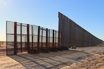 U.S. Army Corps of Engineers contractors place temporary fencing across gaps in the border barrier at the BMGR-1 border barrier project site near Yuma, Arizona, Oct. 28. Each day, at the end of panel installation, contractors place temporary fencing across gaps in the border barrier. USACE is replacing permanent border barriers along the southern border of the U.S. at the direction of the U.S. Army by the Secretary of War, in response to the presidential national emergency declaration dated Jan. 20, 2025, authorizing the use of Section 2803 of Title 10, U.S. Code.