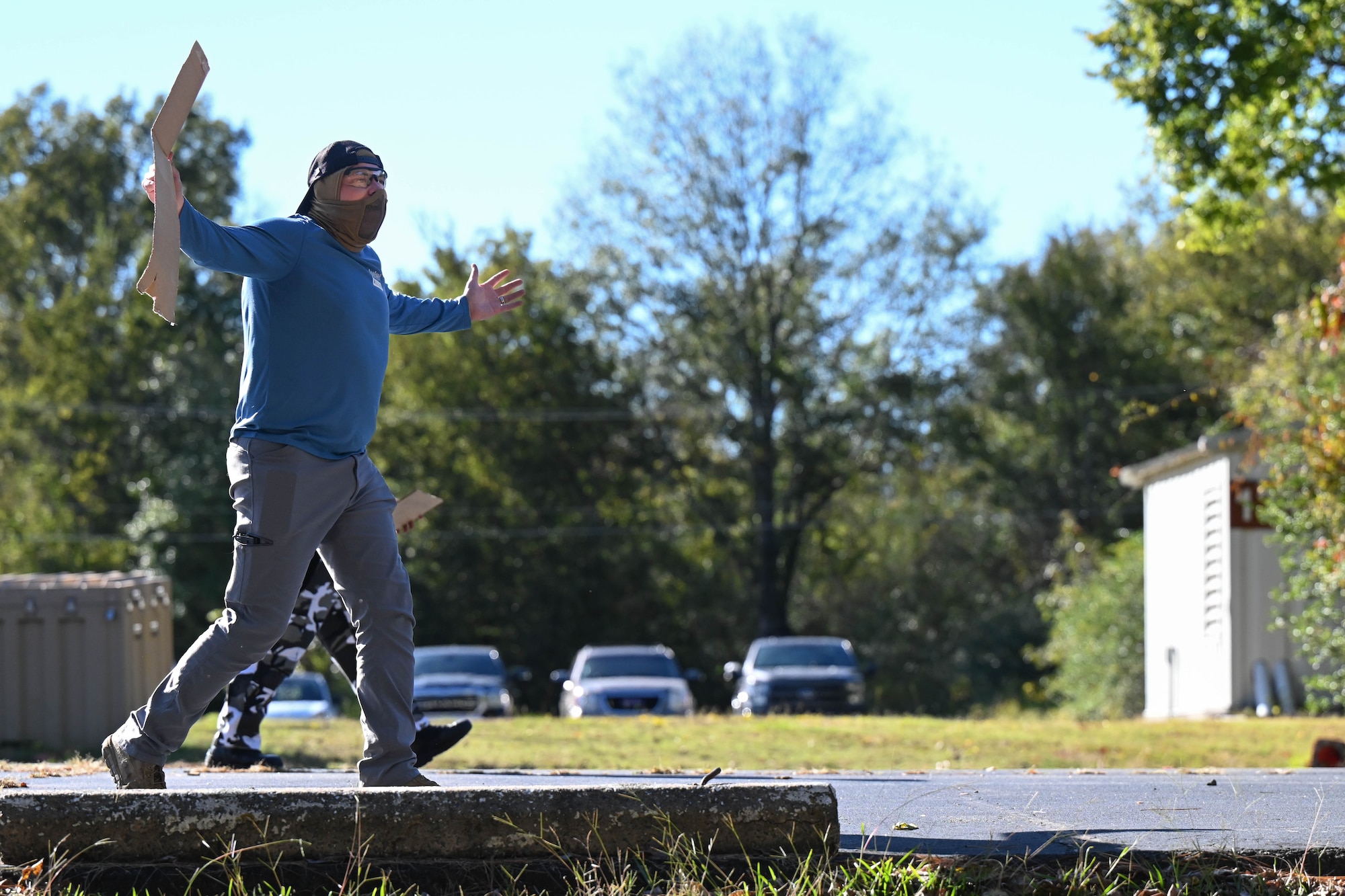 A man walks with a sign in the street.