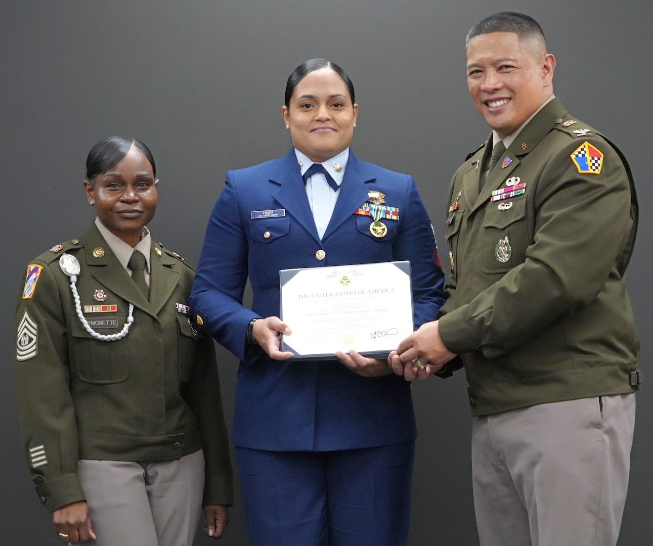 Command Sgt. Maj. Yveline Symonette, USMEPCOM senior enlisted advisor, and Col. Frankie Cochiaosue, USMEPCOM commander, present Petty Officer 2nd Class Kristy Fricks, Houston MEPS medical specialist, with a joint service commendation medal. Petty Officer 2nd Class Kristy Fricks was selected as USMEPCOM's Military Member of the Year and in the same week was selected on the 2026 Interservice Physician Assistant Program.