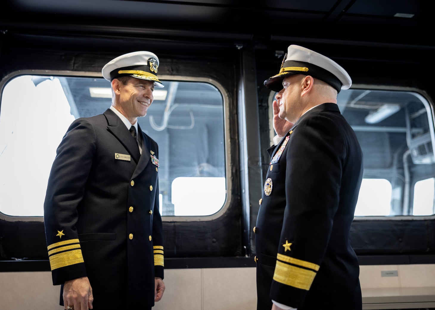 Rear Adm. Benjamin R. Nicholson, prospective Commander, Military Sealift Command (MSC), right, renders a salute to Vice Adm. John Gumbleton, acting Commander, U.S. Fleet Forces Command, and assumes the role of commanding officer during MSC’s assumption of command ceremony held on board USNS Robert F. Kennedy  (T-AO 208) Nov. 13, 2025. The ceremony is a time-honored tradition that marked the moment a new commander formally takes charge of a unit in the absence of an outgoing commander.