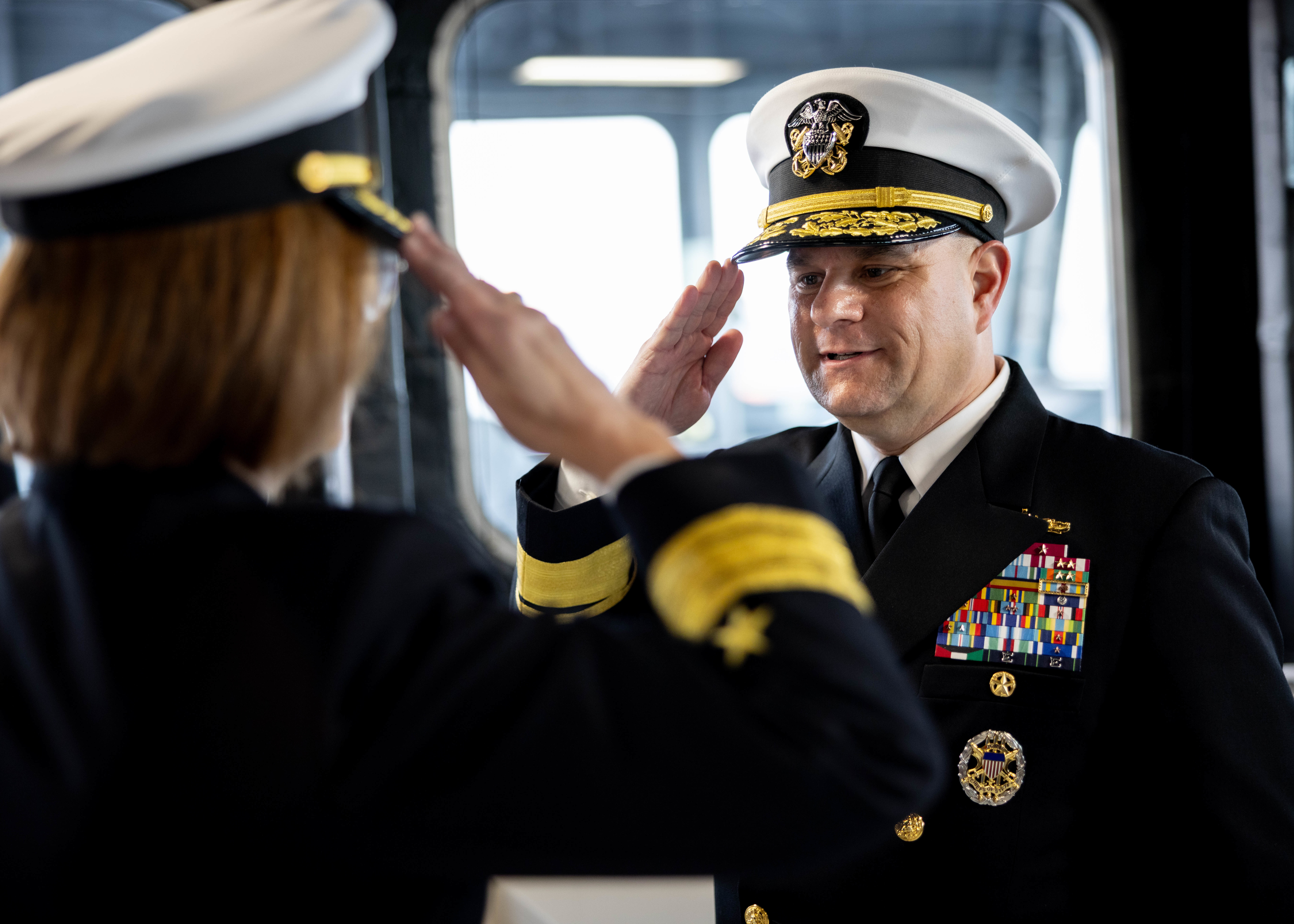 Rear Adm. Benjamin R. Nicholson, prospective Commander, Military Sealift Command (MSC), right, renders a salute to Vice Adm. John Gumbleton, acting Commander, U.S. Fleet Forces Command, and assumes the role of commanding officer during MSC’s assumption of command ceremony held on board USNS Robert F. Kennedy  (T-AO 208) Nov. 13, 2025. The ceremony is a time-honored tradition that marked the moment a new commander formally takes charge of a unit in the absence of an outgoing commander.