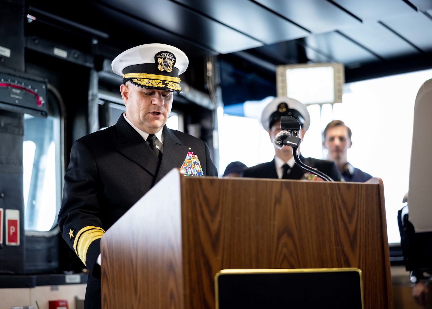 Rear Adm. Benjamin R. Nicholson, prospective Commander, Military Sealift Command (MSC), reads his orders during MSC’s assumption of command ceremony held on board USNS Robert F. Kennedy  (T-AO 208) Nov. 13, 2025. The ceremony is a time-honored tradition that marked the moment a new commander formally takes charge of a unit in the absence of an outgoing commander.