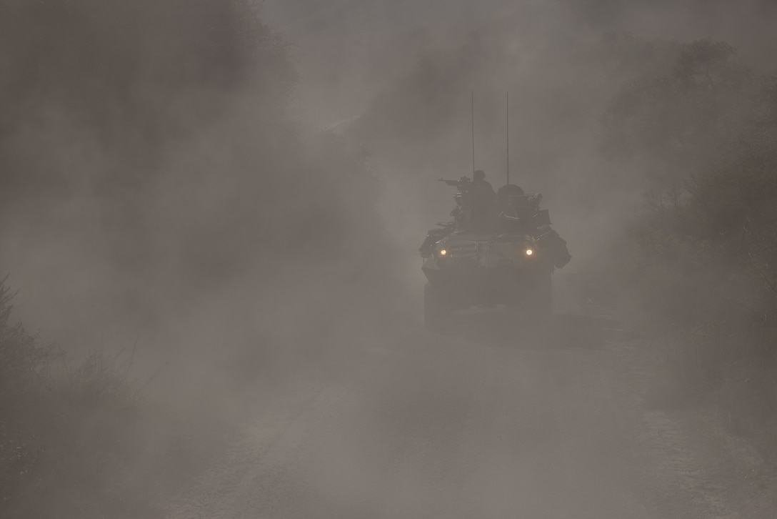 U.S. Marines with 1st Light Armored Reconnaissance Battalion, 1st Marine Division, drive a light armored vehicle through dust during a tactical recovery of aircraft and personnel course at Marine Corps Base Camp Pendleton, California, Nov. 6, 2025.