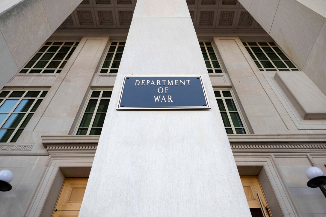 A plaque on a wall reads "Department of War."