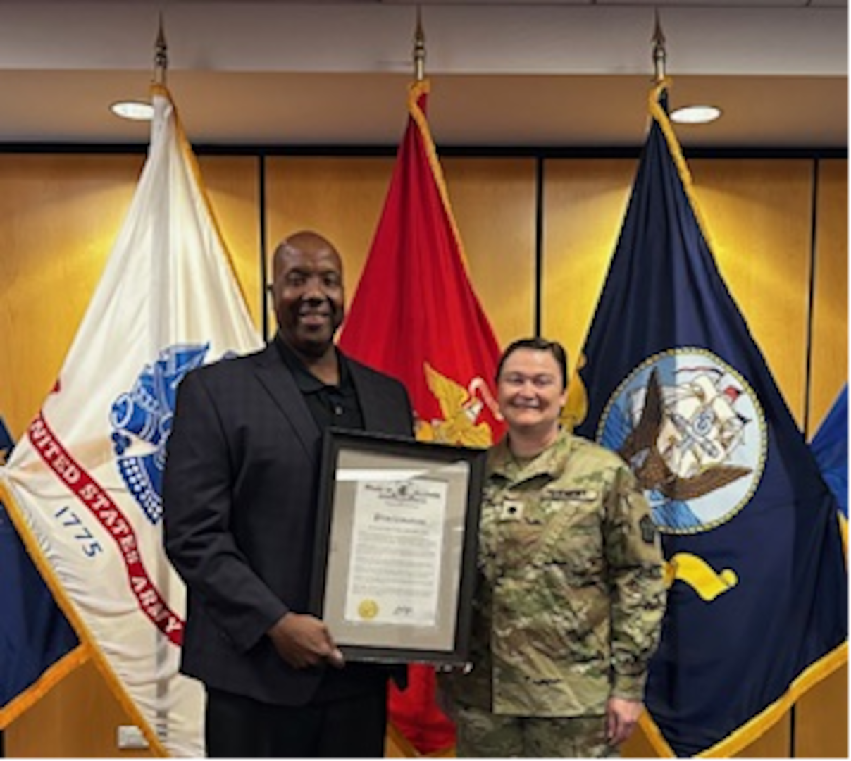 Dr. Johnny D. Jones, Chicago MEPS Education Services Specialist, poses with LTC Loren Petersen holding a proclamation from Illinois Governor JB Pritzker. Illinois Governor JB Pritzker issued a proclamation recognizing Dr. Jones for his innovative efforts in advancing the Armed Services Vocational Aptitude Battery (ASVAB) Career Exploration Program (CEP) and piloting the School Staff Testing (SST) model across Illinois.