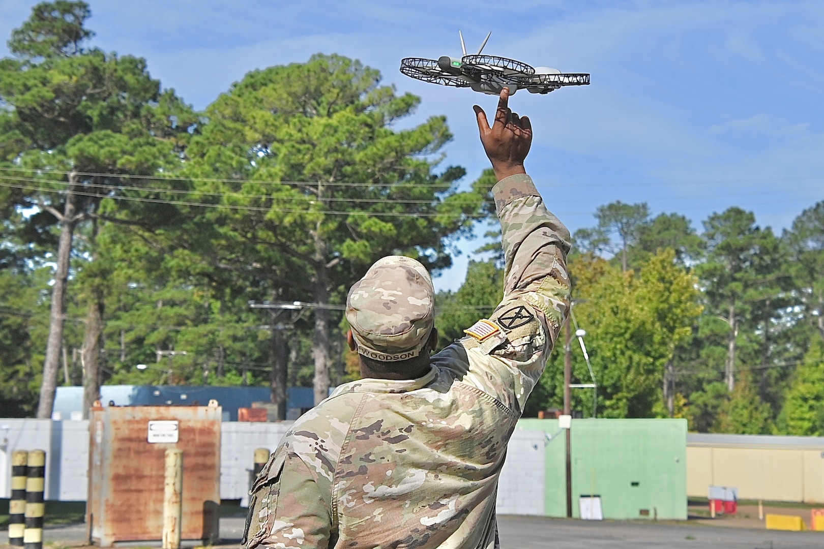 Soldier launching a hand-held, quad-copter drone.