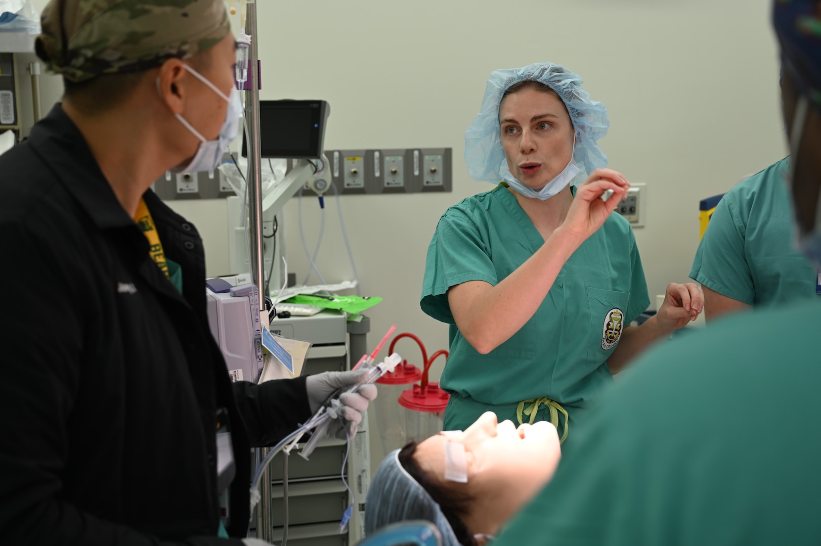 Dr. Ulinski provides feedback to the team during a malignant hyperthermia simulation at Carl R. Darnall Army Medical Center, ensuring all participants understand the importance of training for rare emergency scenarios.