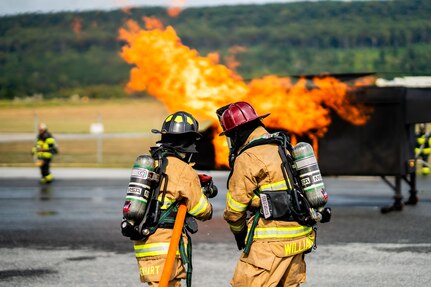 U.S. Soldiers with the 192nd Firefighter Detachment, 337th Engineer Battalion, 55th Maneuver Enhancement Brigade fight a simulated aircraft fire during an exercise with the Fort Indiantown Gap Fire Department at Fort Indiantown Gap, Pennsylvania, Sept. 16, 2025. The training utilized a helicopter fire simulator to enhance the Soldiers’ readiness to respond to aviation-related emergencies in both domestic and deployed environments. (U.S. Army National Guard photo by Sgt. Du-Marc Mills)