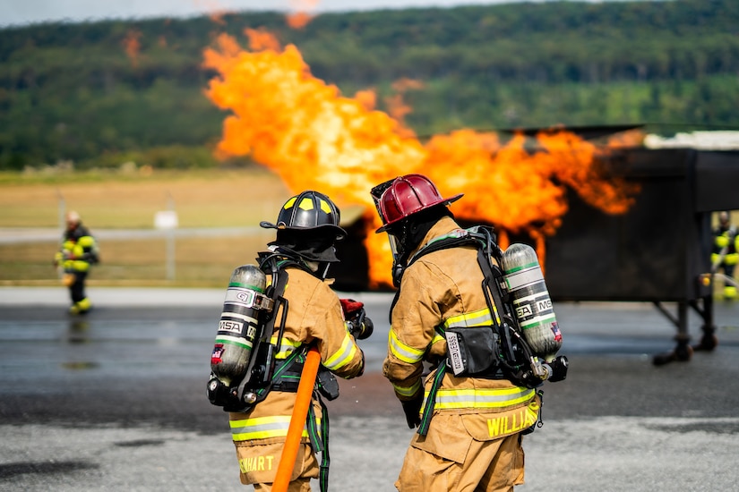 U.S. Soldiers with the 192nd Firefighter Detachment, 337th Engineer Battalion, 55th Maneuver Enhancement Brigade fight a simulated aircraft fire during an exercise with the Fort Indiantown Gap Fire Department at Fort Indiantown Gap, Pennsylvania, Sept. 16, 2025. The training utilized a helicopter fire simulator to enhance the Soldiers’ readiness to respond to aviation-related emergencies in both domestic and deployed environments. (U.S. Army National Guard photo by Sgt. Du-Marc Mills)