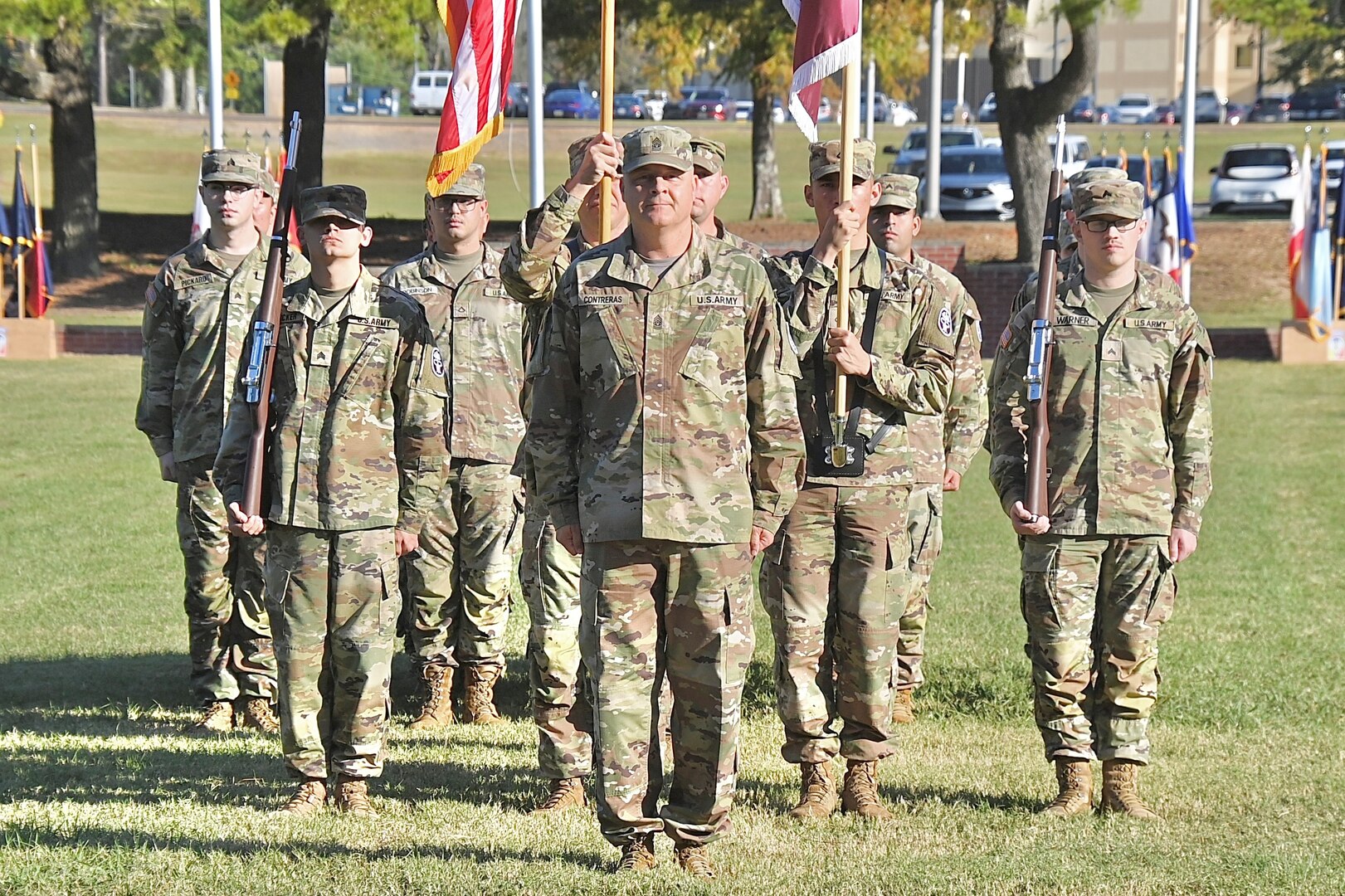 The Hospital's new Senior Enlisted Leader stands at the head of a formation of Soldiers on a parade field.