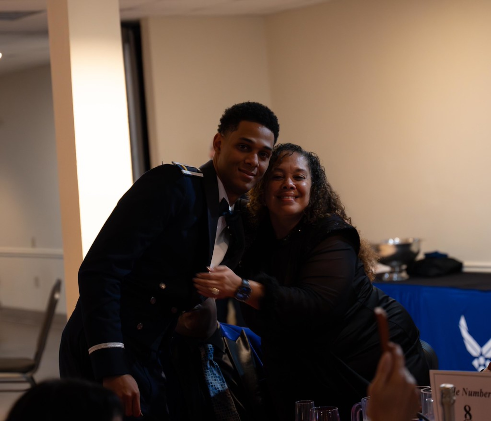 A student pilots and their guest pose for a photo.