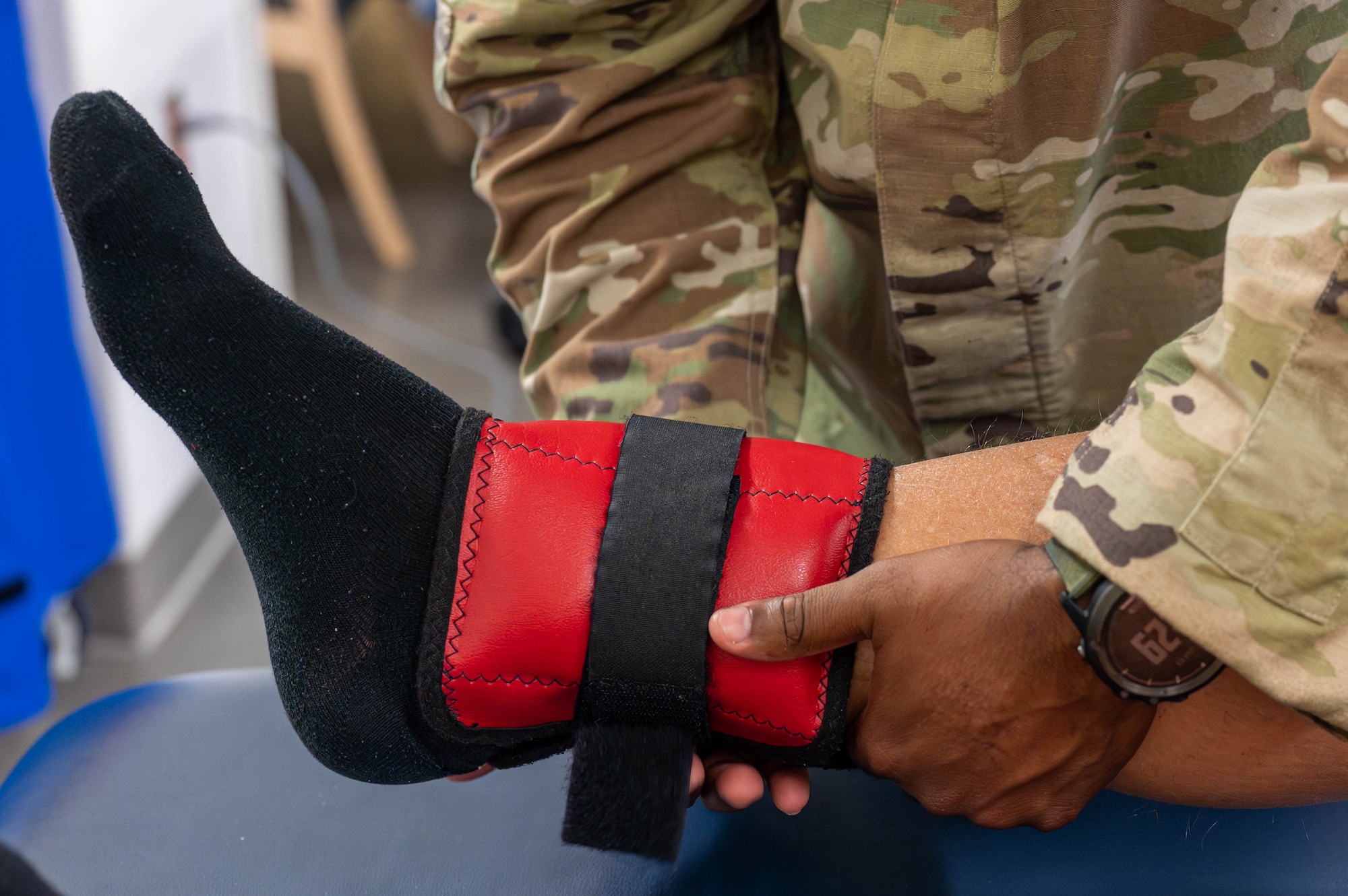 U.S. Air Force Tech. Sgt. Brandon Fisher, 325th Operational Medical Readiness Squadron human performance flight chief, examines a patient’s leg at Tyndall Air Force Base.