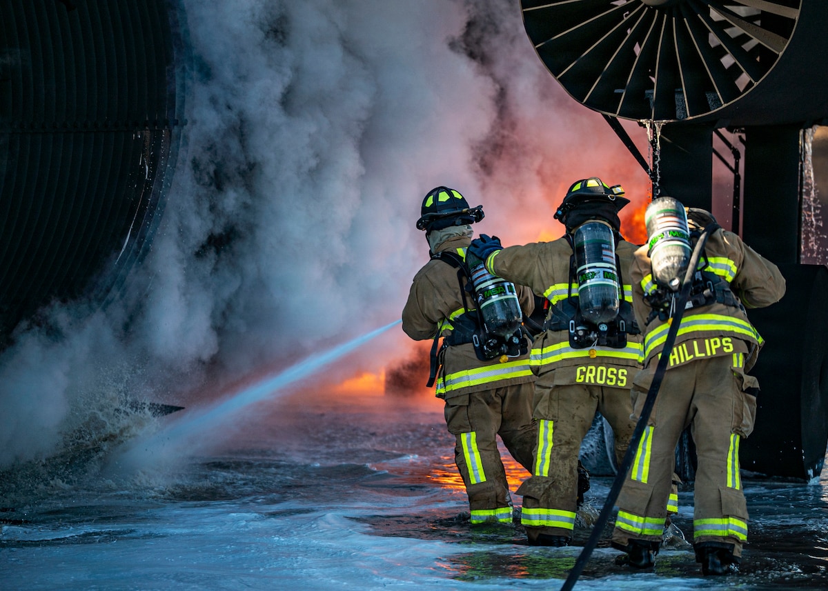 Firefighters assigned to the 23d Combat Air Base Squadron practice extinguishing a large-scale training fire during exercise Silver Flag at Tyndall Air Force Base, Florida, Nov. 12, 2025. The exercise gave Airmen hands-on experience in responding to high-intensity fires in deployed environments. (U.S. Air Force photo by Senior Airman Leonid Soubbotine)