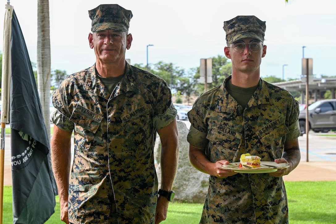 U.S. Marine Corps Col. Anthony Lyons, assistant chief of staff for the aviation division, Marine Forces, Pacific, left, the most senior Marine in attendance, and U.S. Marine Corps Cpl. Stephen Holland, the youngest Marine, pose for a photo after a cake-cutting ceremony at the Daniel K. Inouye Center for Excellence on Joint Base Pearl Harbor-Hickam, HI, Nov. 4, 2025.