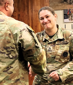 Col. Shawn Nokes presents Sgt. 1st Class Kayla Alberstett, a senior instructor in the 92G (culinary specialist) program, with the Gordon Ramsey award.