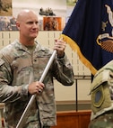 Col. Paul Metzdorff receives the 129th Regiment (Regional Training Institute) guidon from Brig. Gen. Lenny Williams.