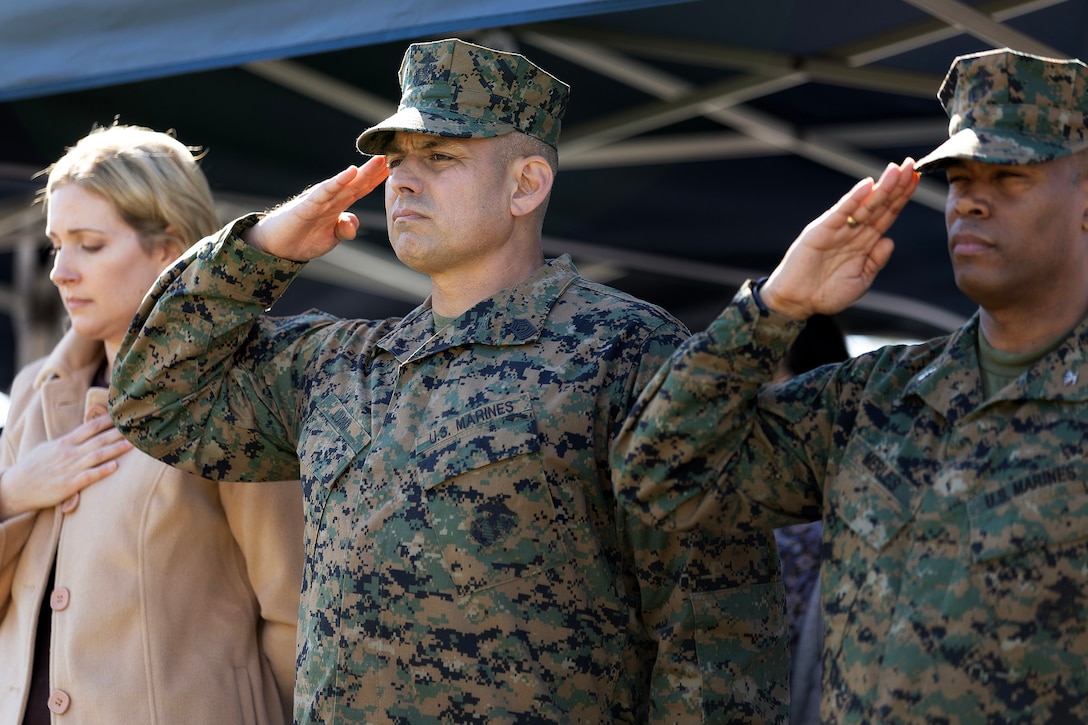 U.S. Marine Corps Sgt. Maj. Julian Lumm salutes during the playing of the "Star Spangled Banner" at the Nov. 14 relief and appointment ceremony at Marine Corps Support Facility Blount Island, Florida. Lumm is retiring after 30 years of service, marking the conclusion of his tenure as the first sergeant major of Blount Island Command. (Official Marine Corps Photo by Dustin Senger)