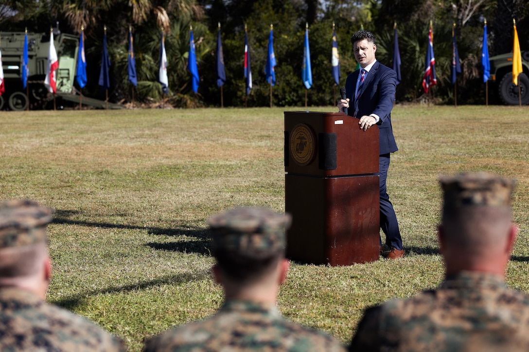 Daniel Kachmar, deputy director of interagency and data services for VA Electronic Health Record Modernization and a retired U.S. Marine staff sergeant, speaks to the audience during the Nov. 14 relief and appointment ceremony at Marine Corps Support Facility Blount Island, Florida. Kachmar, who served alongside Sgt. Maj. Julian Lumm in Afghanistan and Iraq, honored Lumm’s leadership and legacy as he retired after 30 years of service. (Official Marine Corps Photo by Dustin Senger)