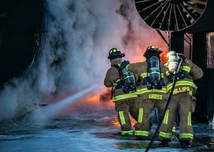 Firefighters assigned to the 23d Combat Air Base Squadron practice extinguishing a large-scale training fire during exercise Silver Flag at Tyndall Air Force Base, Florida, Nov. 12, 2025. The exercise gave Airmen hands-on experience in responding to high-intensity fires in deployed environments. (U.S. Air Force photo by Senior Airman Leonid Soubbotine)