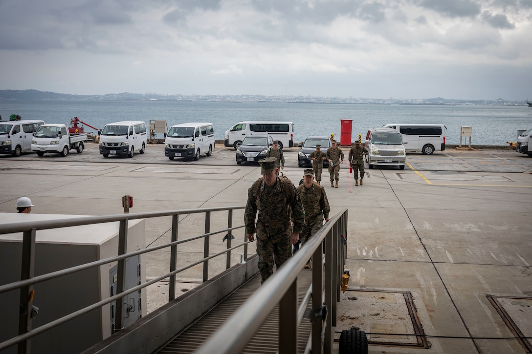 U.S. Marine Corps Col. Chris Niedziocha, the commanding officer of the 31st Marine Expeditionary Unit, and 31st MEU staff embark the light amphibious assault ship USS Tripoli (LHA 7) at White Beach Naval Facility, Okinawa, Japan, Oct. 26, 2025. The embarkation was an opportunity for the 31st MEU to integrate with their U.S. Navy counterparts aboard the USS Tripoli. The 31st MEU, the Marine Corps’ only continuously forward deployed MEU, provides a flexible and lethal force, ready to perform a wide range of military operations as the premiere crisis response force in the Indo-Pacific region. (U.S. Marine Corps Photo by Lance Cpl. Trevor BishopWilliams)