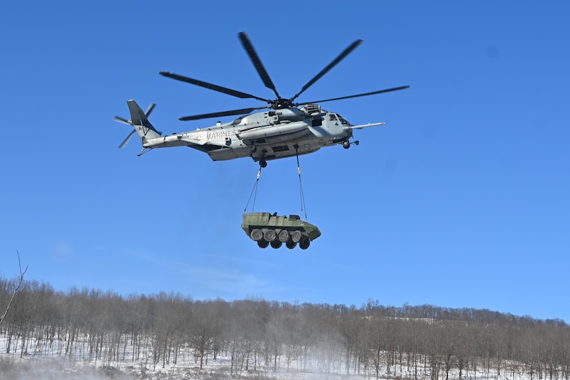A Marine CH-53 Super Stallion helicopter from Marine Heavy Helicopter Squadron 772 out of Joint Base Maguire-Dix-Lakehurst, New Jersey, air-lifts a decommissioned Army Stryker vehicle to Fort Indiantown Gap’s impact area Jan. 22, 2025. A team of Air Force sling-load specialists from the 621st Contingency Response Group sling-loaded the Stryker to the helicopter. (Pennsylvania National Guard photo by Brad Rhen)