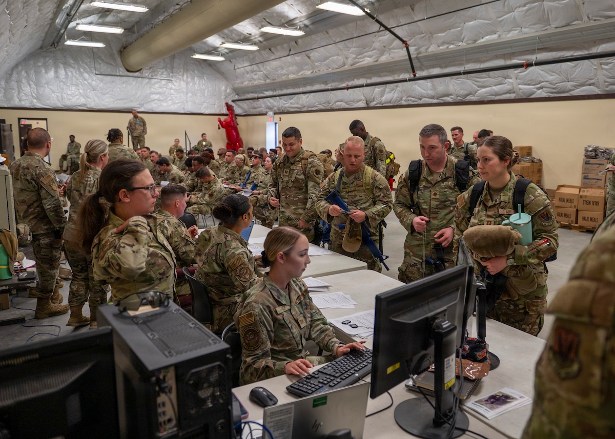 U.S. Air Force Airmen in-process for exercise Mosaic Tiger 26-1 at Tyndall Air Force Base, Florida, Nov. 15, 2025. The in-processing line ensured participants were properly equipped, accounted for and prepared to operate, MT 26-1 tested the wing’s ability to disperse, sustain and command combat operations from multiple forward locations under contested conditions. (U.S. Air Force photo by Senior Airman Leonid Soubboutine)