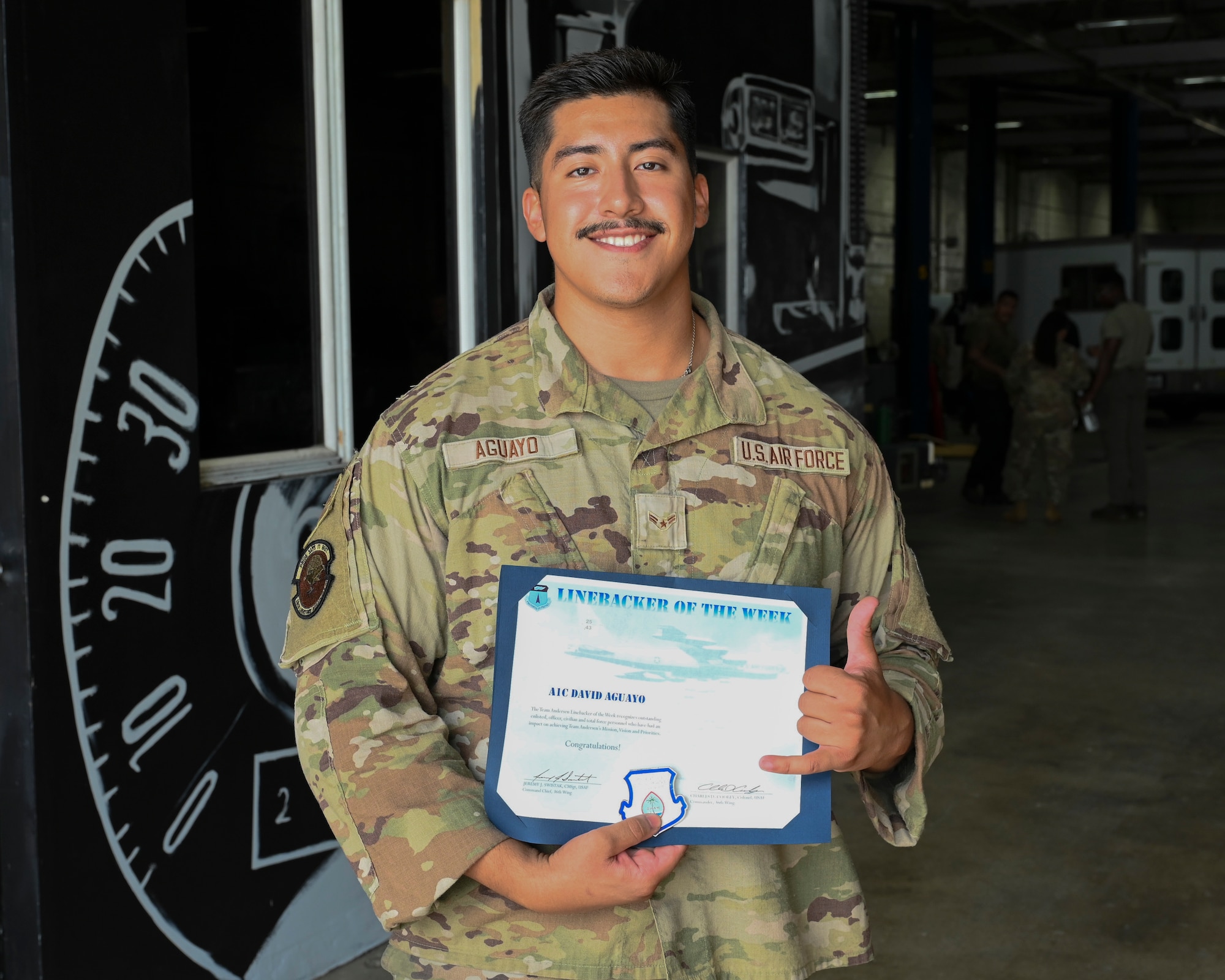 Airman 1st Class David Aguayo, 36th Logistics Readiness Squadron material control technician, receives the Linebacker of the Week recognition by the 36th Wing Command Team at Andersen Air Force Base, Guam, Oct. 23, 2025.