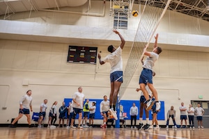 People jumping in air during a volleyball game