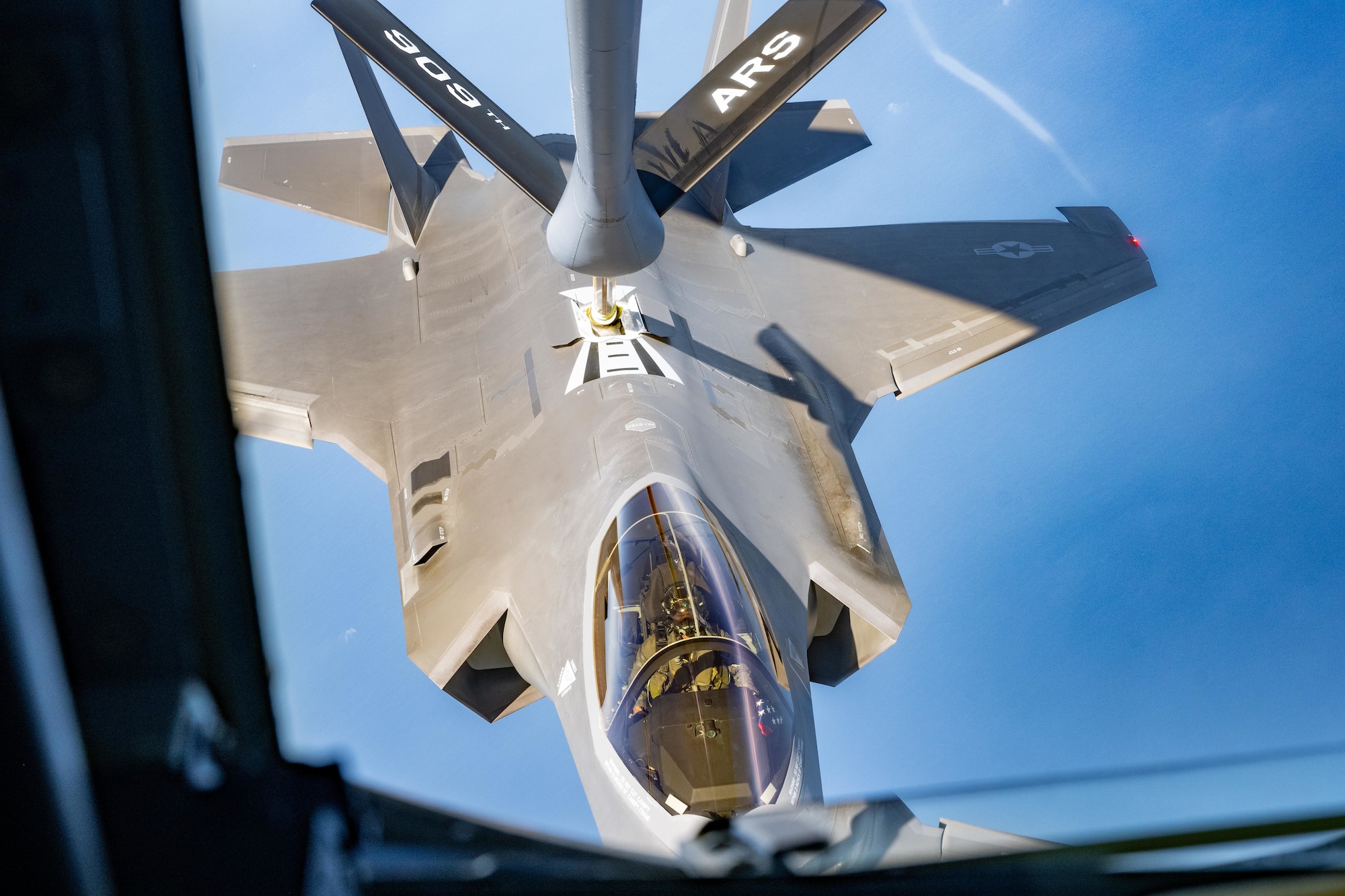 A U.S. Air Force KC-135 Stratotanker assigned to the 909th Air Refueling Squadron refuels an F-35A Lightning II assigned to the 421st Fighter Squadron over the Pacific Ocean during a refueling mission in preparation of Exercise Bushido Guardian 2025.