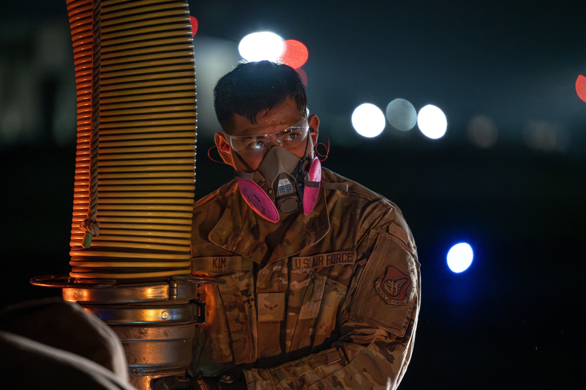 A military member uses a vacuum during rapid airfield damage repair.