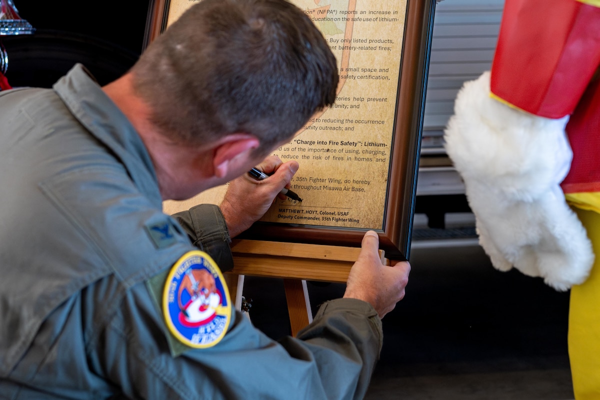 U.S. Air Force Col. Matthew Hoyt, 35th Fighter Wing deputy commander, signs the Fire Prevention Week 2025 proclamation.